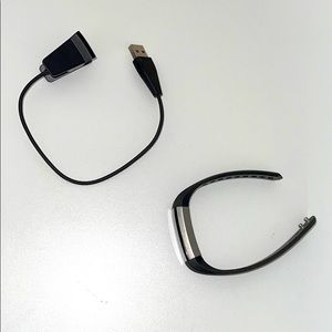 Black Fitbit with charger.